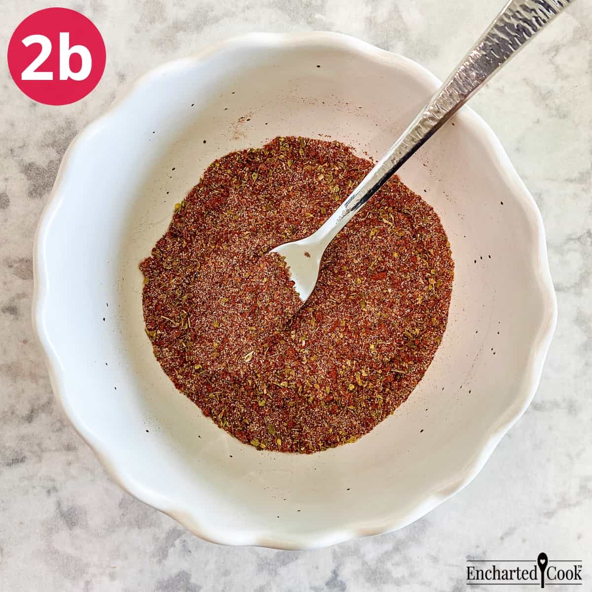 Process Photo 2b - The seasonings are mixed together in a small bowl with a fork to make a spice rub for the chicken.