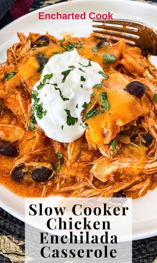 A serving of a casserole of red enchilada sauce, shredded chicken, cheddar cheese, and corn tortillas on a white plate with a fork with text overlay.