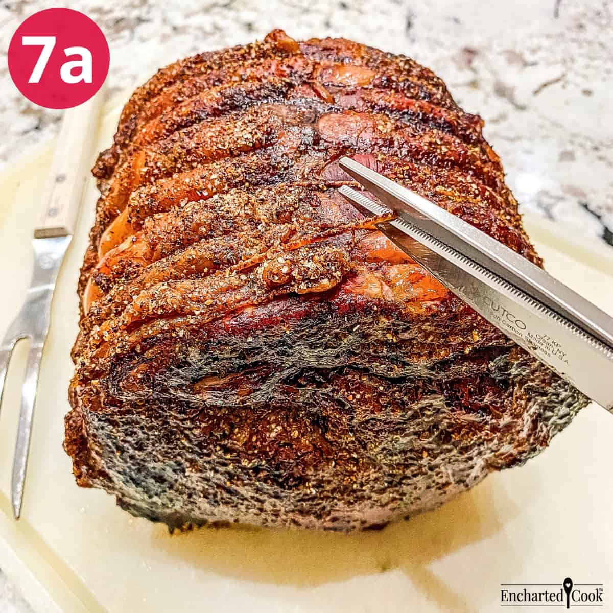 Process Photo 7a - Snipping the string tying the roast to the ribs with kitchen shears.