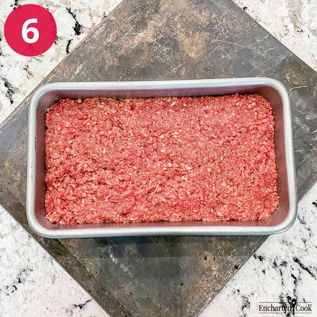 Process Photo 6 - The meatloaf mixture is pressed into a large loaf pan.