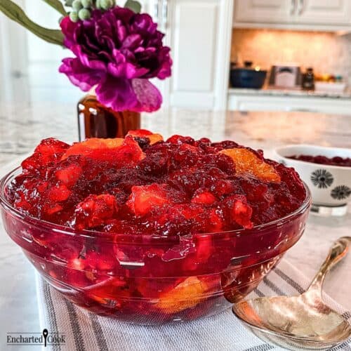 Cranberry Jello salad in a bowl and ready to be served with a spoon.