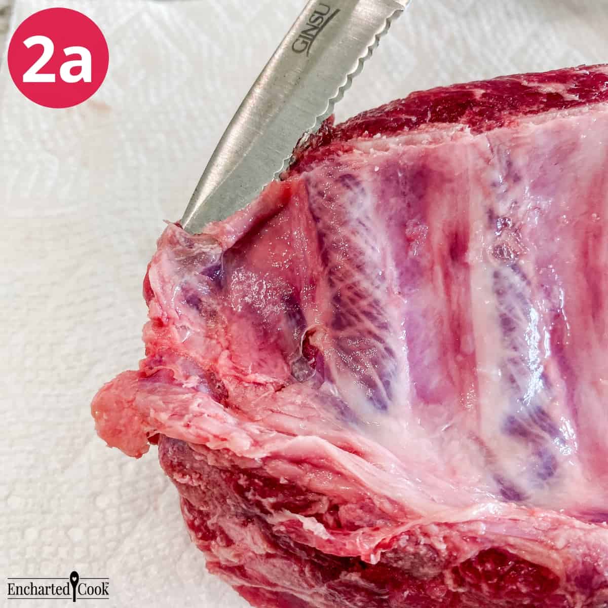 Process Photo 2a - A small paring knife is used to separate the edge of the silver skin from the ribs at the small end.