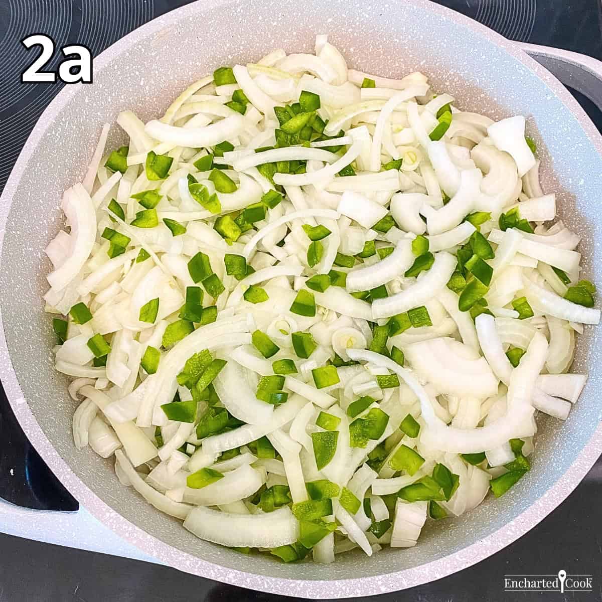 Process Photo 2a - Cooking sliced onions and diced green pepper in olive oil in a large pan.