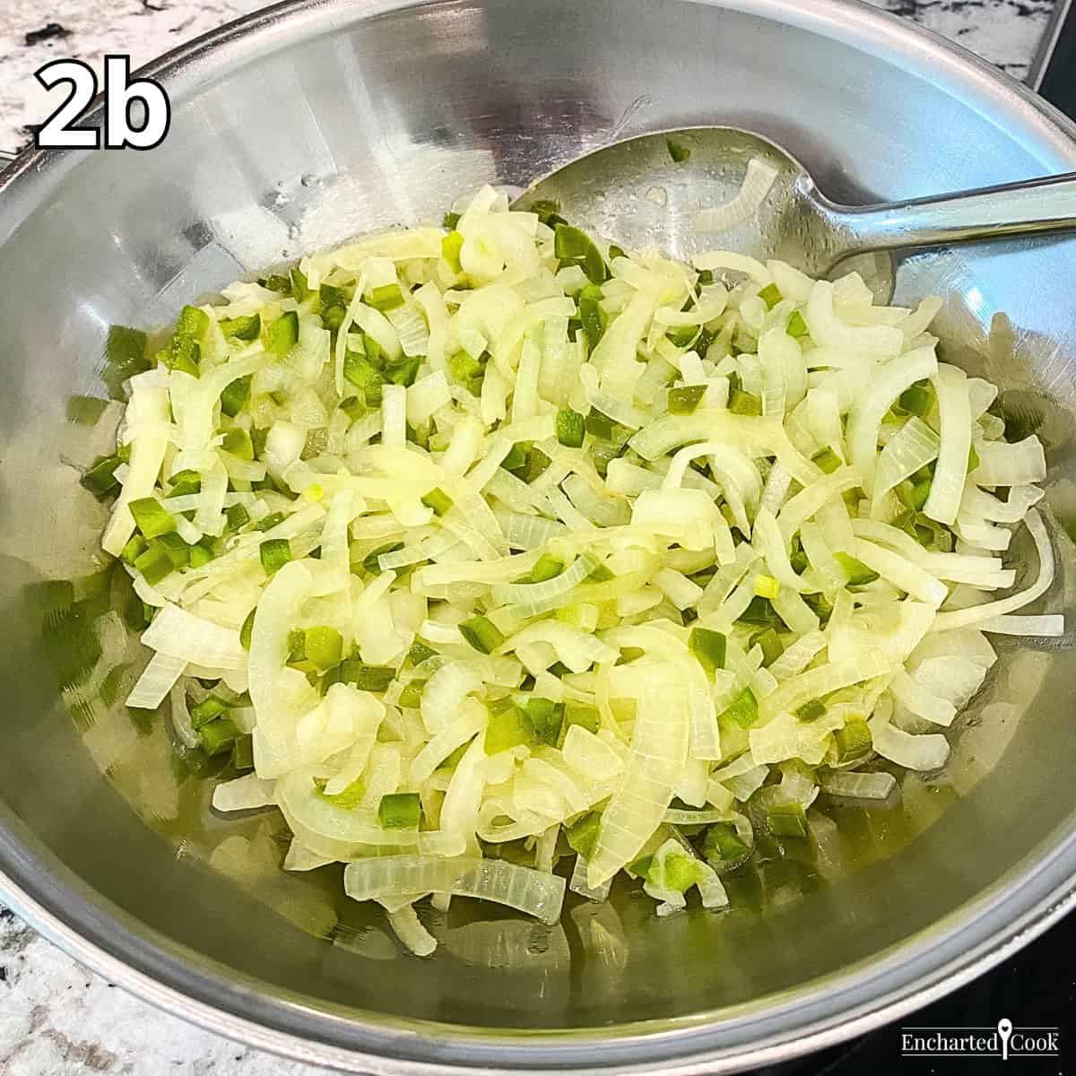 Process Photo 2b - The cooked onions and bell peppers are transferred to a large mixing bowl.