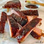 Oven Baked Barbecue Ribs smothered in barbecue sauce and ready to eat.