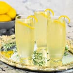Elderflower and Lemon Mimosas in stemless flutes on a small tray.