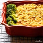 Tuscan Turkey Divan in ared casserole containing leftover turkey and broccoli in an alfredo and extra cheese sauce.