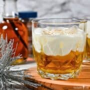 A Maple Beam and Cream Cocktail over ice in a small rocks glass.