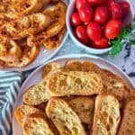 Parmesan Crostini on two white plates two ways, with and without paprika.