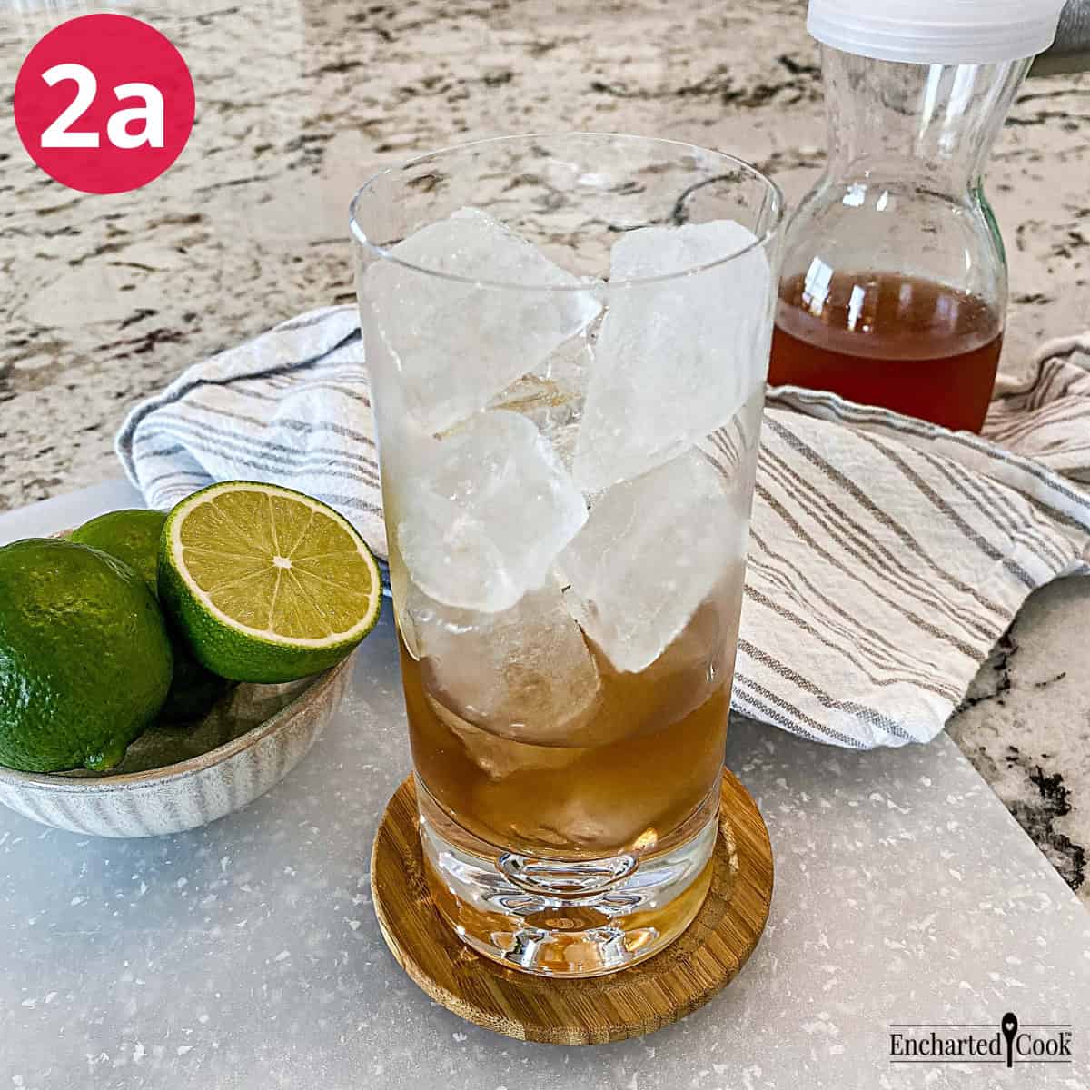 Process Photo 2a - A glass filled with ice cubes and a small amount of ginger simple syrup.