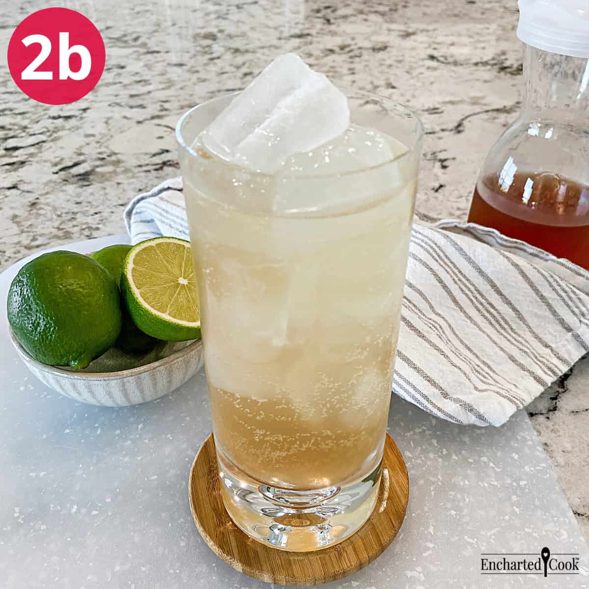 Process Photo 2b - Sparkling water is added to the glass of ice and ginger simple syrup to make homemade ginger ale by the glass.