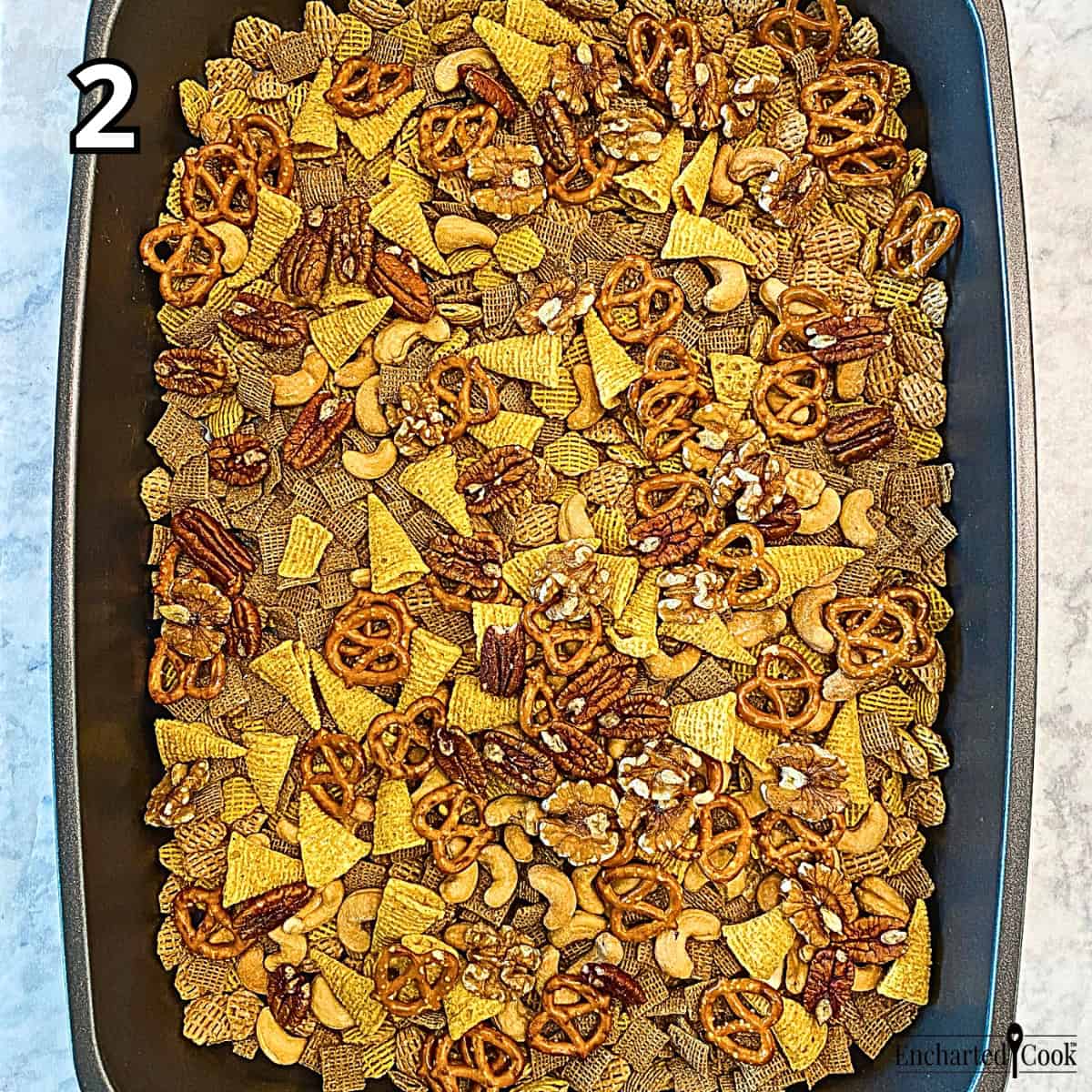 Process Photo 2 - Spreading and mixing the chosen snacks in a large baking pan.