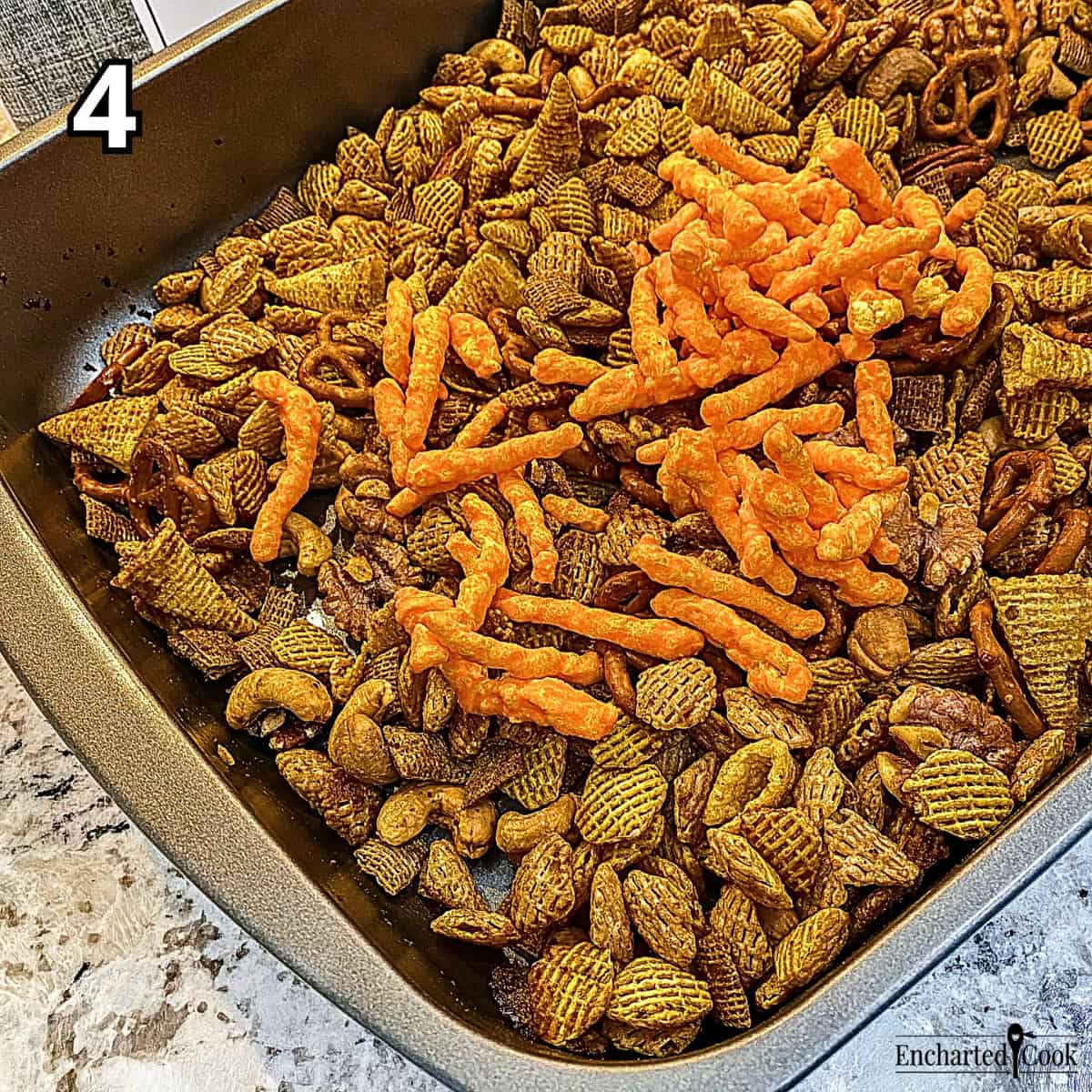 Process Photo 4 - Adding Cheetos to the baked snack mix.