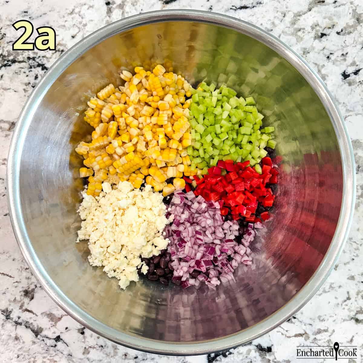 Process Photo 2a - Black beans, corn, diced celery, diced red pepper, diced red onion, and crumbled feta cheese in a large mixing bowl.