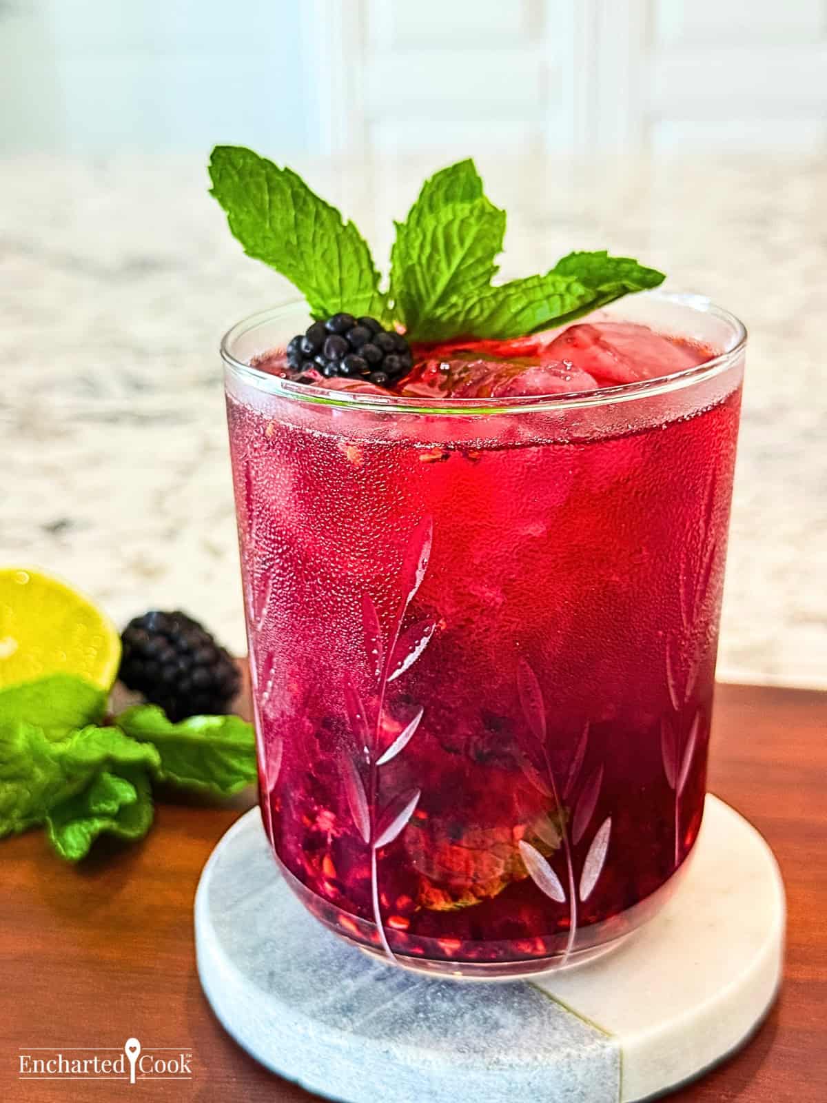 A blackberry and lime cocktail with mint leaves.