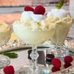 Lemon Cream Fluff in dessert glasses garnished with fresh raspberries and mint.