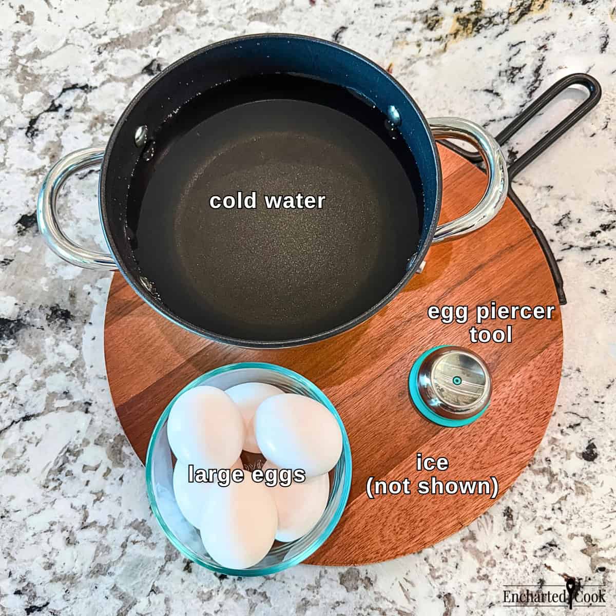 The Ingredients and a special tool, clockwise from top left: cold water, egg piercer tool, ice (not shown), and large eggs.