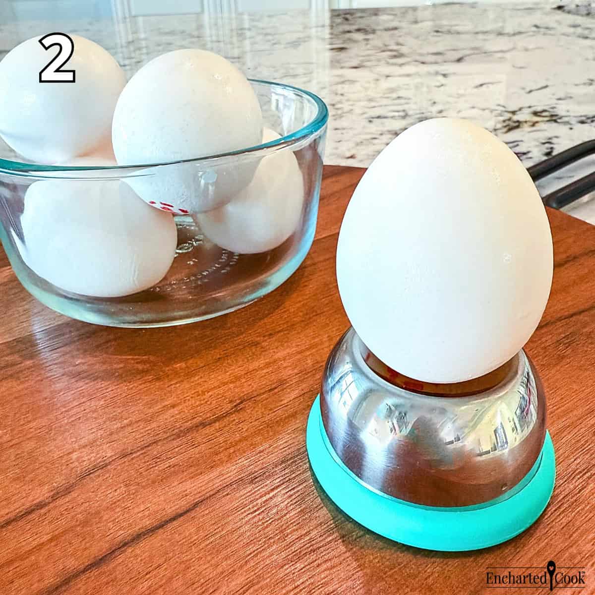 Process Photo 2 - While water is coming to a boil, make a tiny hole in the bottom of the large end of each egg using an egg piercer tool or a push pin.
