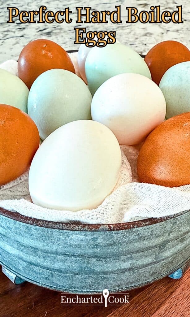 Perfect hard boiled eggs and are in a metal bowl with text overlays.