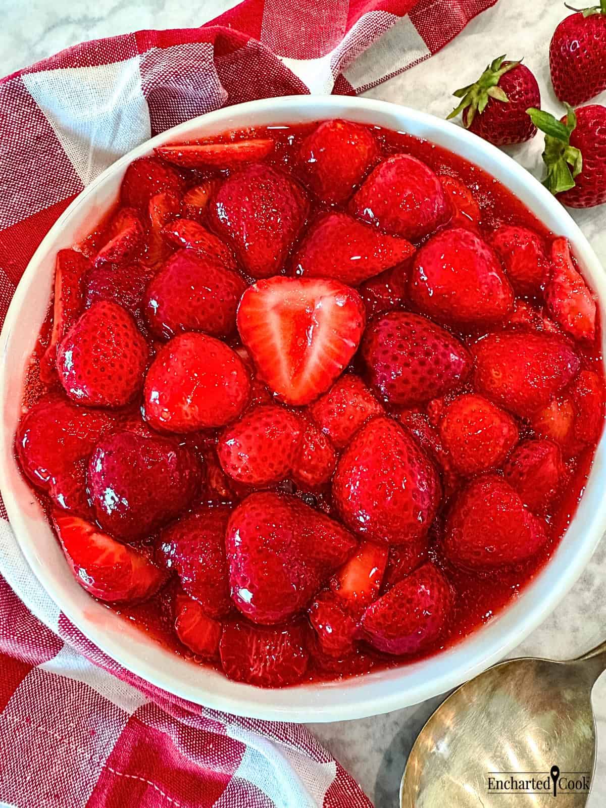 Homemade Strawberry Sauce with sliced fresh strawberries in a white bowl.