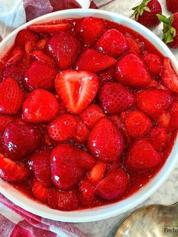 Homemade Strawberry Sauce with sliced fresh strawberries in a white bowl.