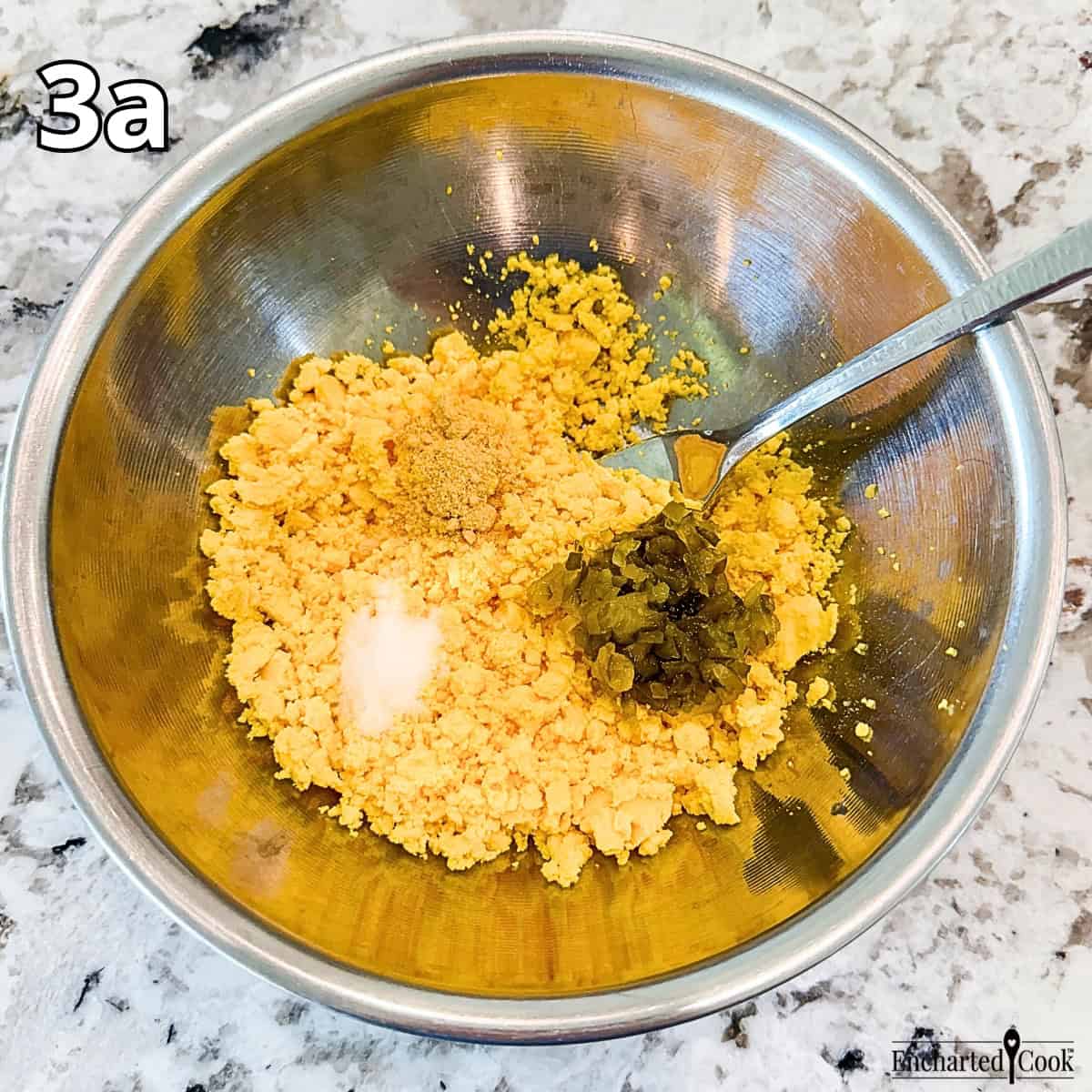 Process Photo 3a - Mashing the yolks and adding salt, dry mustard, mayonnaise, and sweet pickle relish.