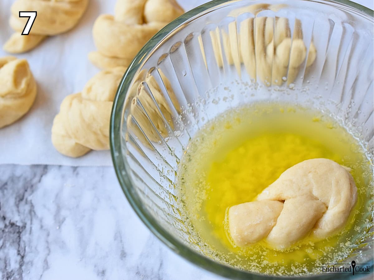 Process Photo 7 - Coating the uncooked bread knots with the garlic butter.
