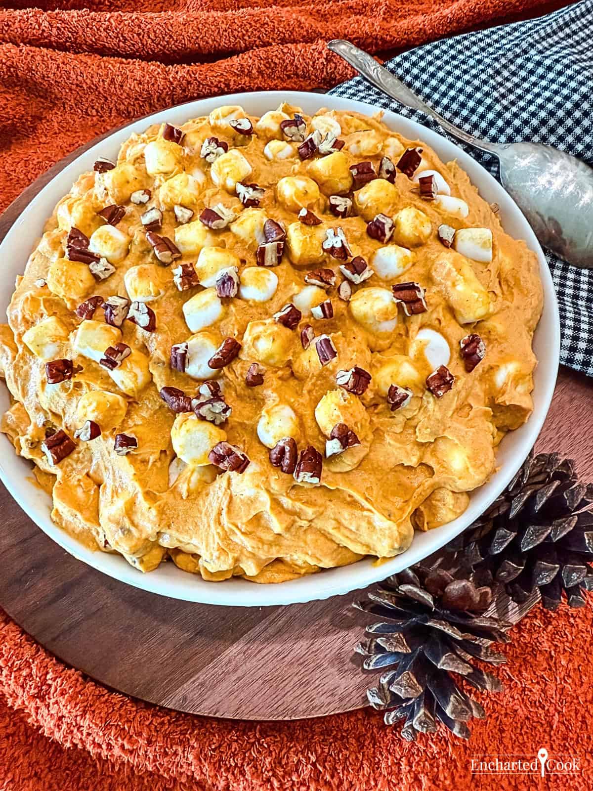 Pumpkin Spice Fluff in a white bowl surrounded with autumn decorations.