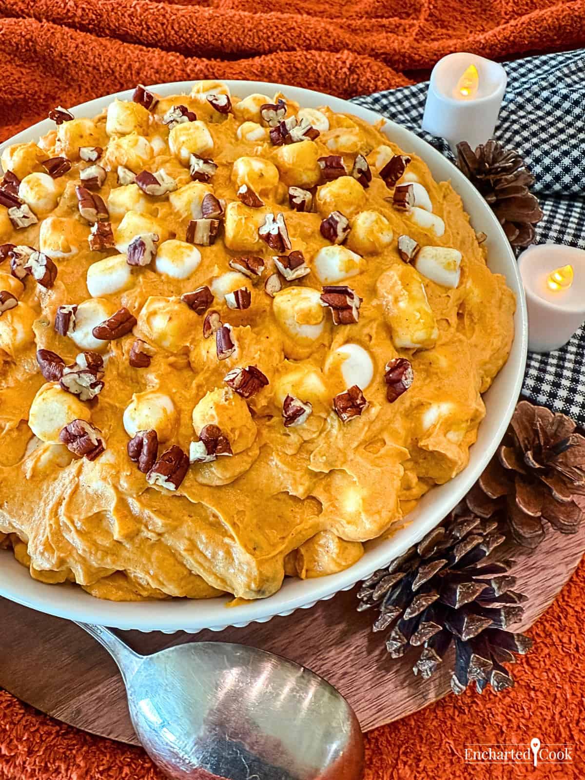 Pumpkin Spice Fluff in a white bowl surrounded with autumn decorations.