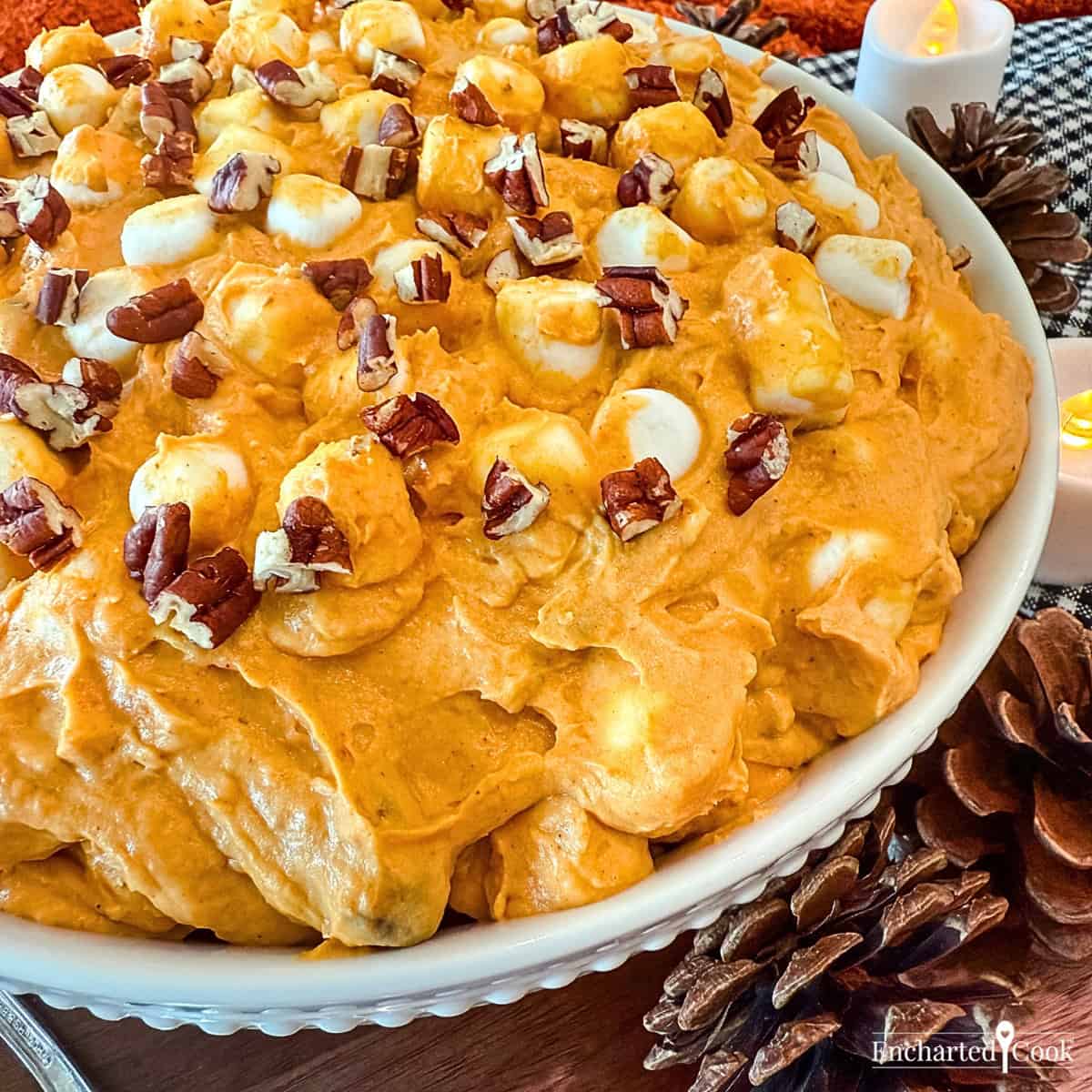 Pumpkin Spice Fluff in a white bowl surrounded with autumn decorations.