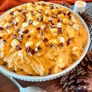 Pumpkin Spice Fluff in a white bowl surrounded with autumn decorations.