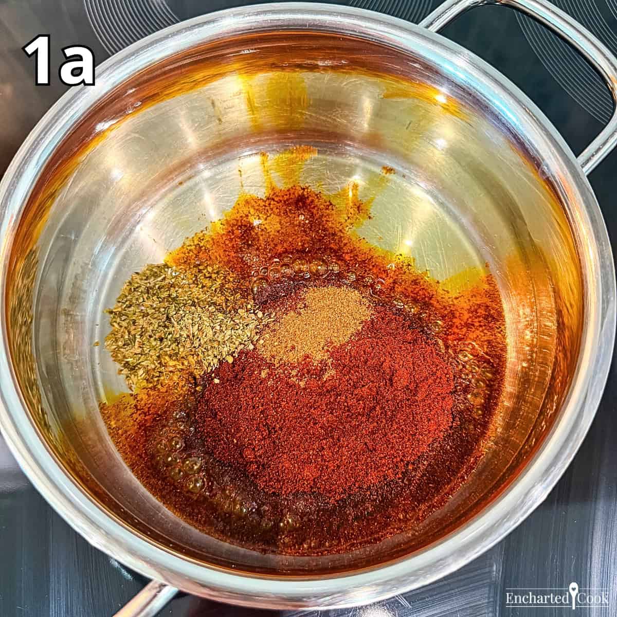 Process Photo 1a - Adding the spices to heated cooking oil in a tall pan.