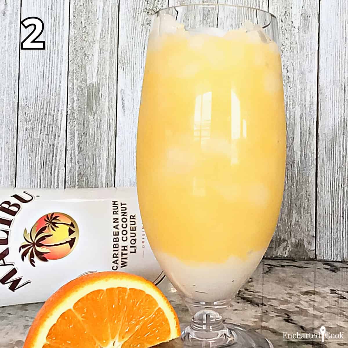 Process Photo 2 - Orange juice mixed with coconut rum is added to the glass.