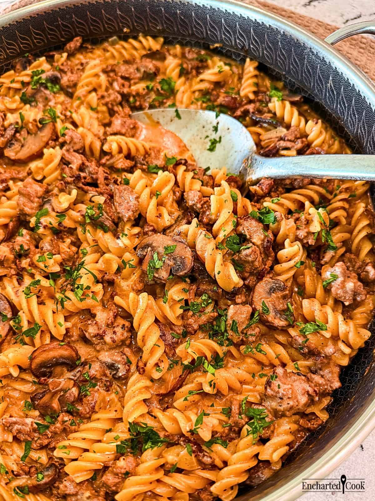 Ground Beef Stroganoff in a large pan with a spoon.
