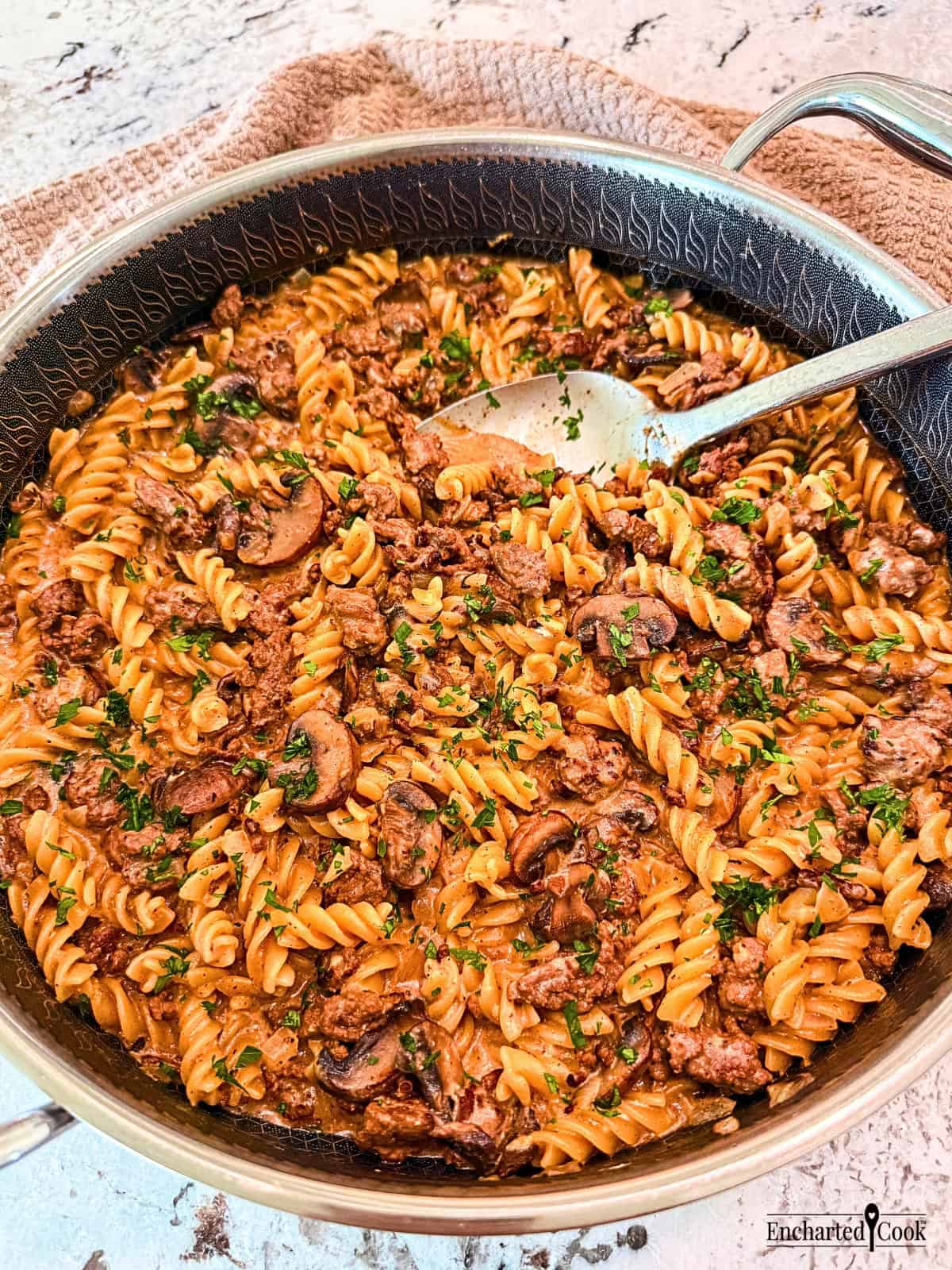 Ground Beef Stroganoff in a large pan with a spoon.