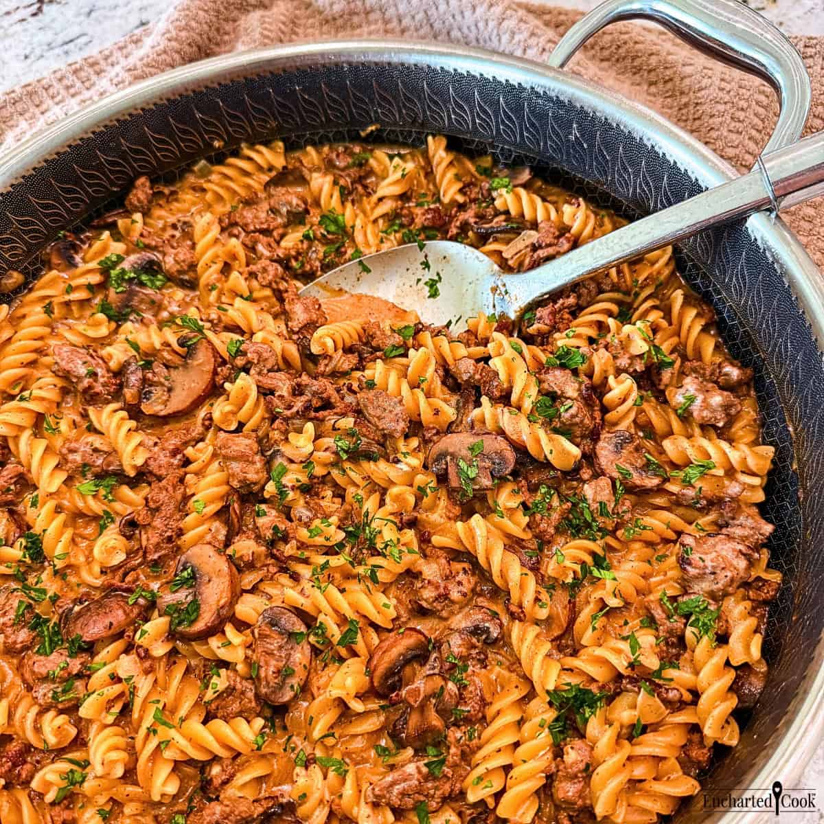 Ground Beef Stroganoff in a large pan with a spoon.
