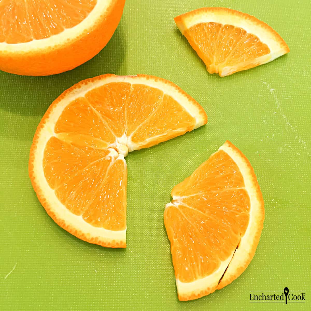 A wedge is cut from an orange slice on a cutting board for a beverage garnish.