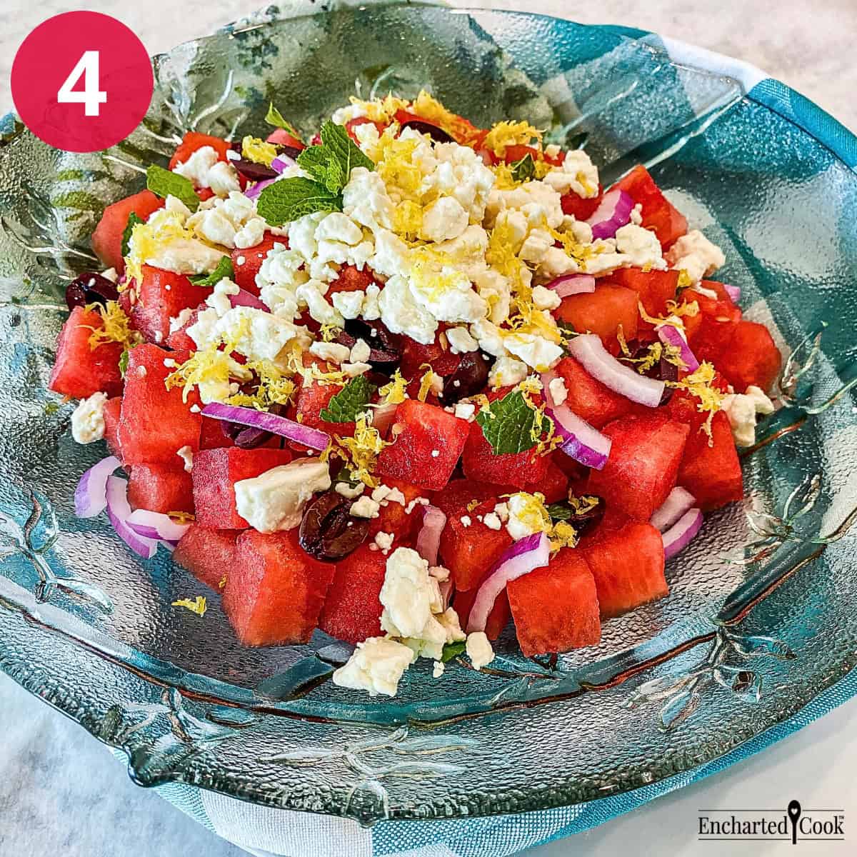 Process Photo 4 - The watermelon salad is dressed with the vinaigrette and garnished with lemon zest and more torn mint leaves.