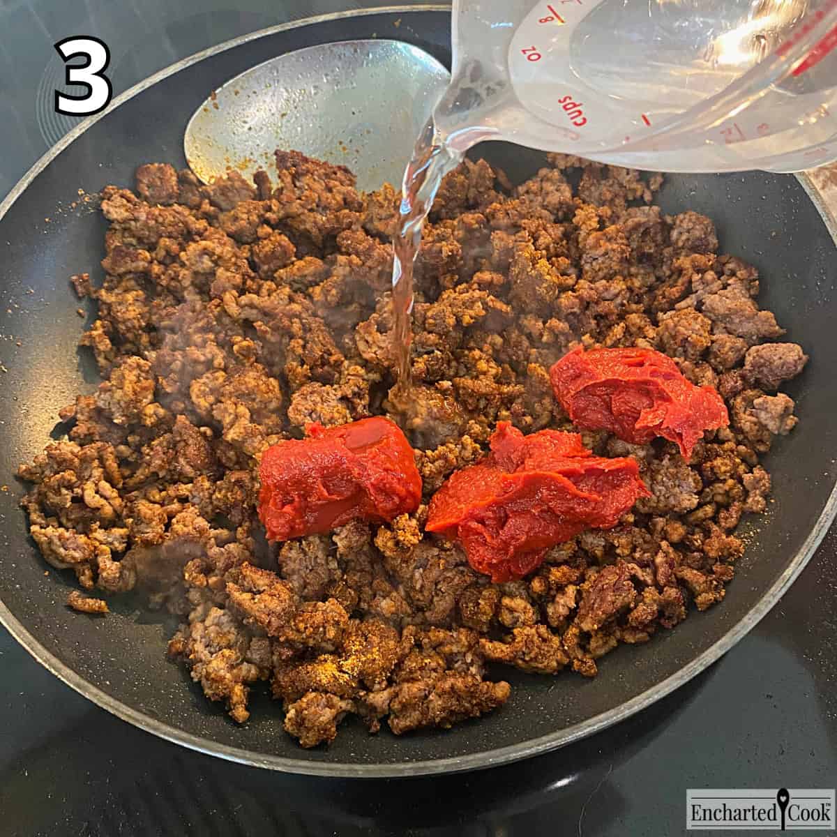 Process Photo 3 - Adding tomato paste and water to the taco seasoned, browned ground beef.