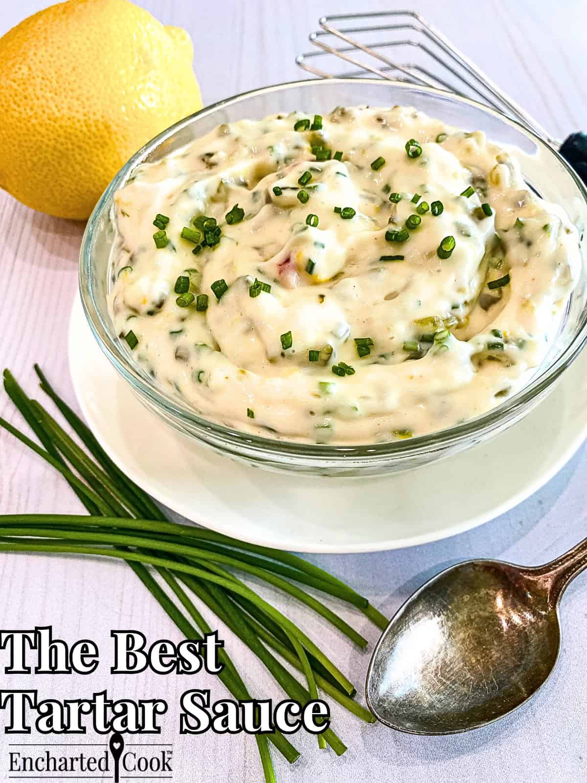 The best tartar sauce in a small glass bowl with a lemon and teaspoon and text overlays.