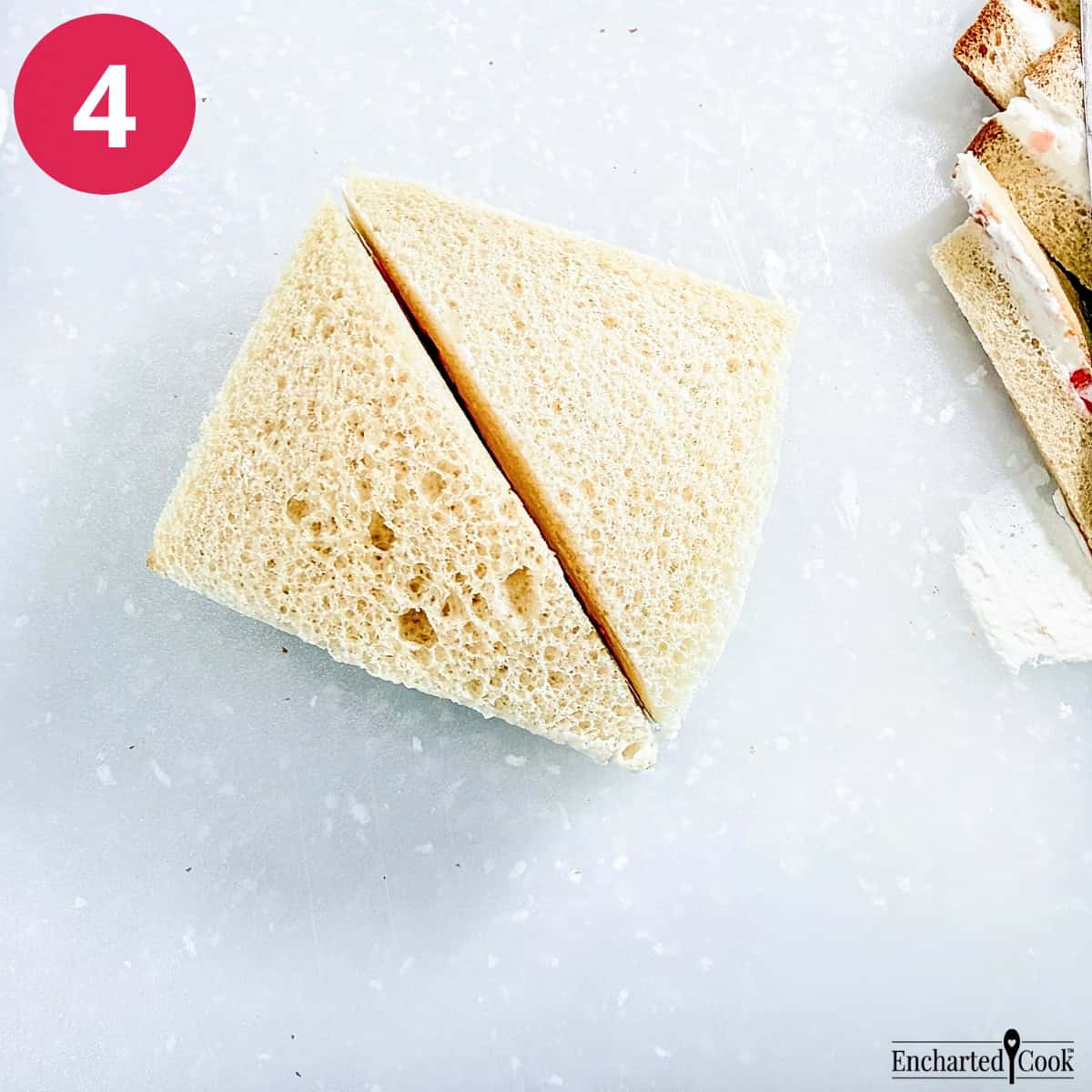Process Photo 4 - With a sharp knife trim away the crusts and cut the sandwiches in half diagonally.