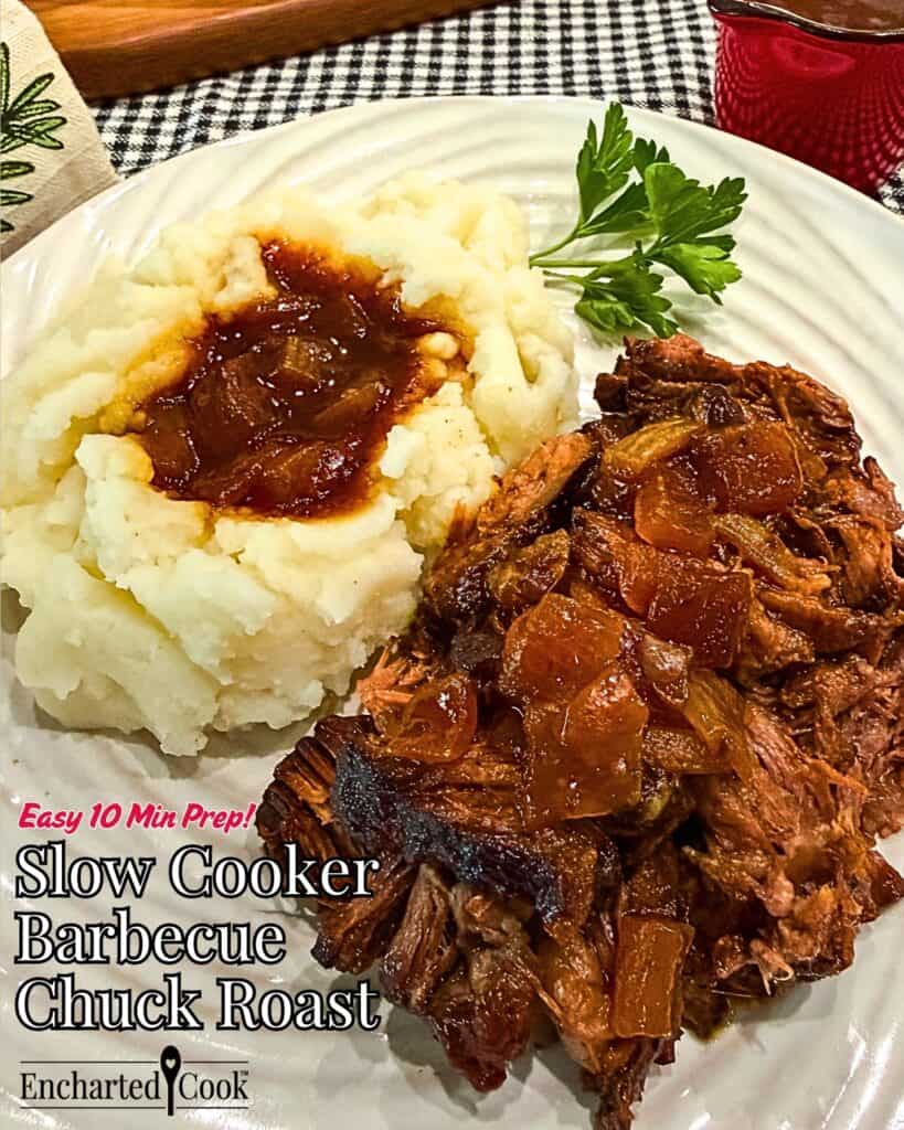Close up view of slow cooker barbecued chuck roast is shredded and served with mashed potatoes and jus poured over the meat and the potatoes with text overlays.