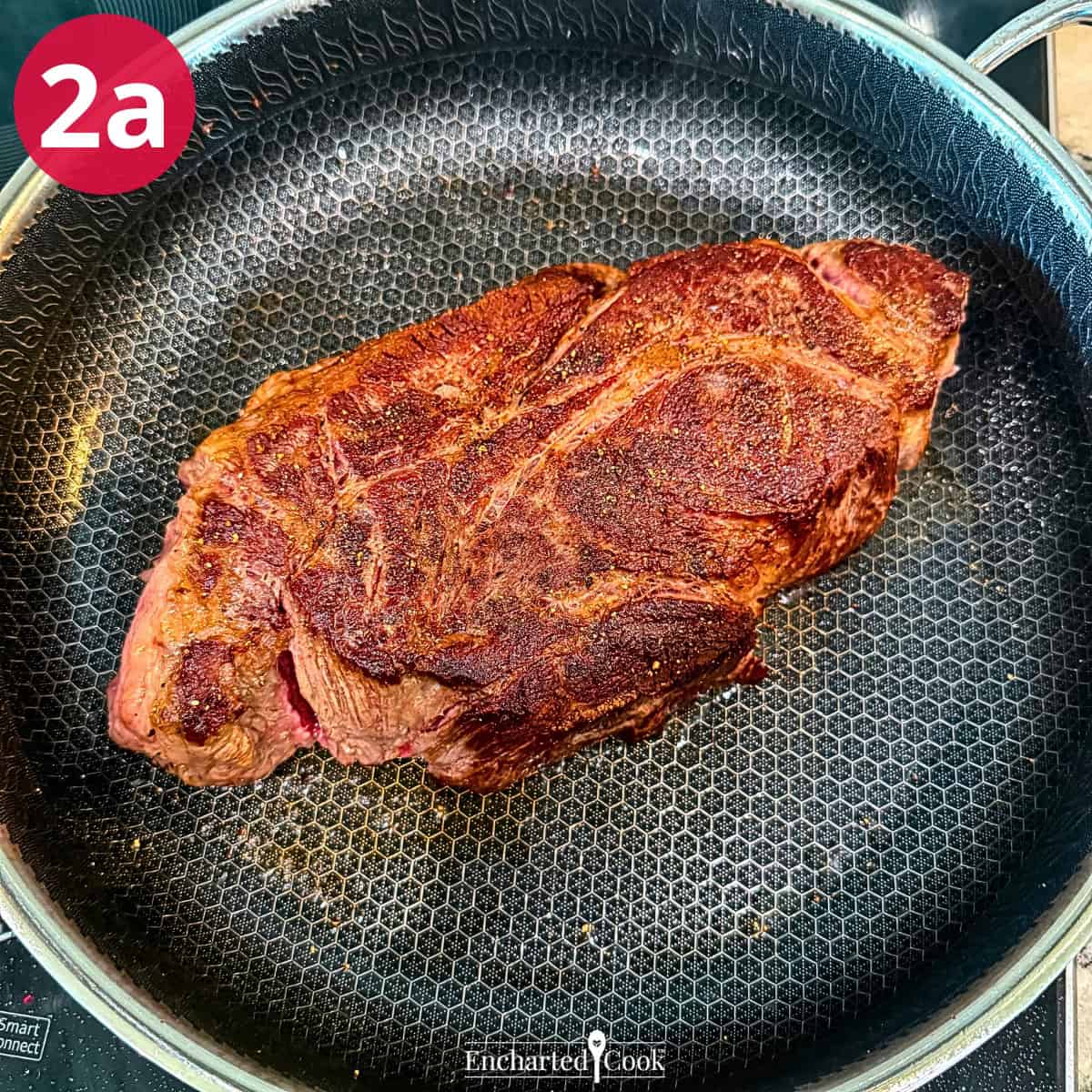 Process Photo 2a - Browning the seasoned chuck roast in a large skillet.