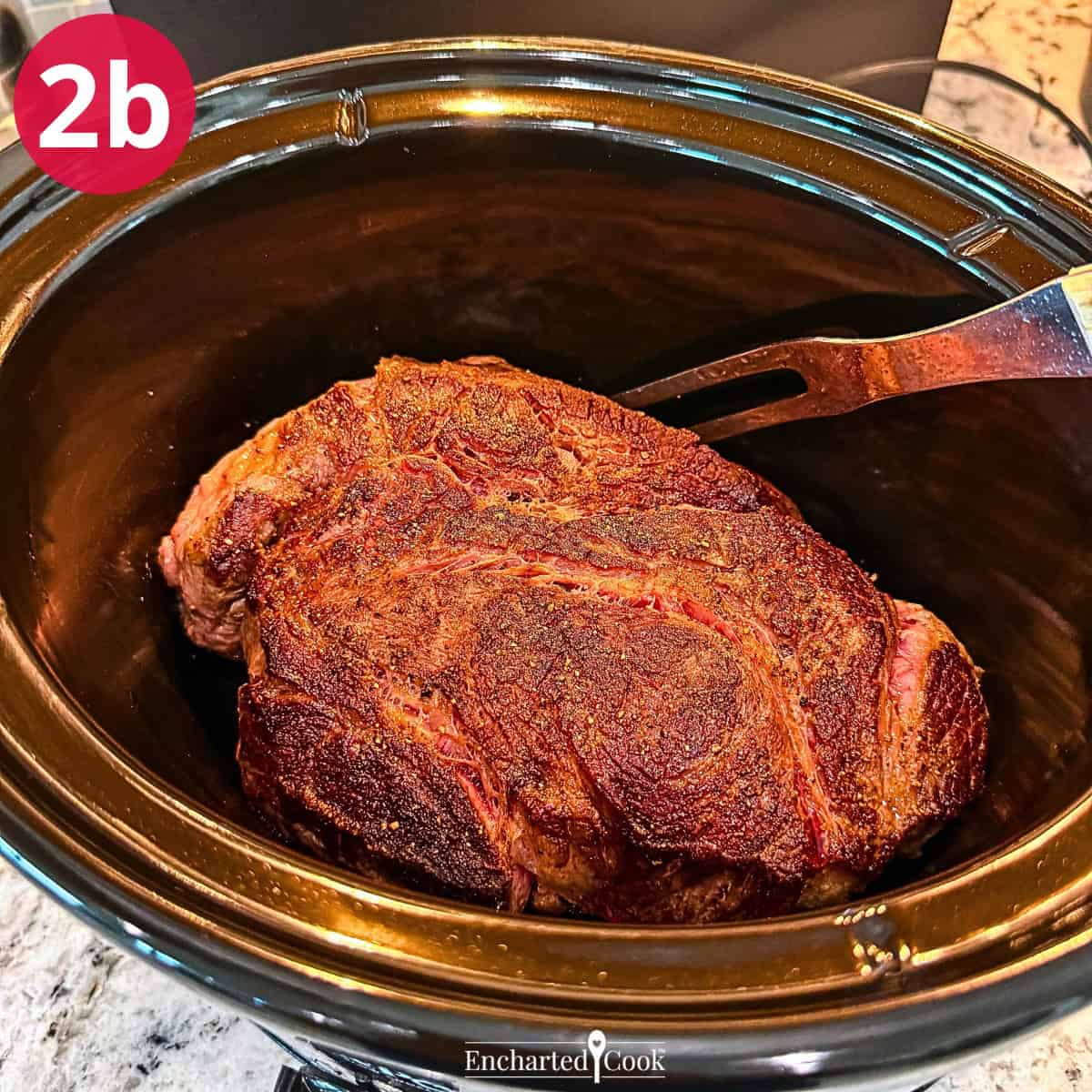 Process Photo 2b - Placing the seasoned and browned chuck roast in the slow cooker.